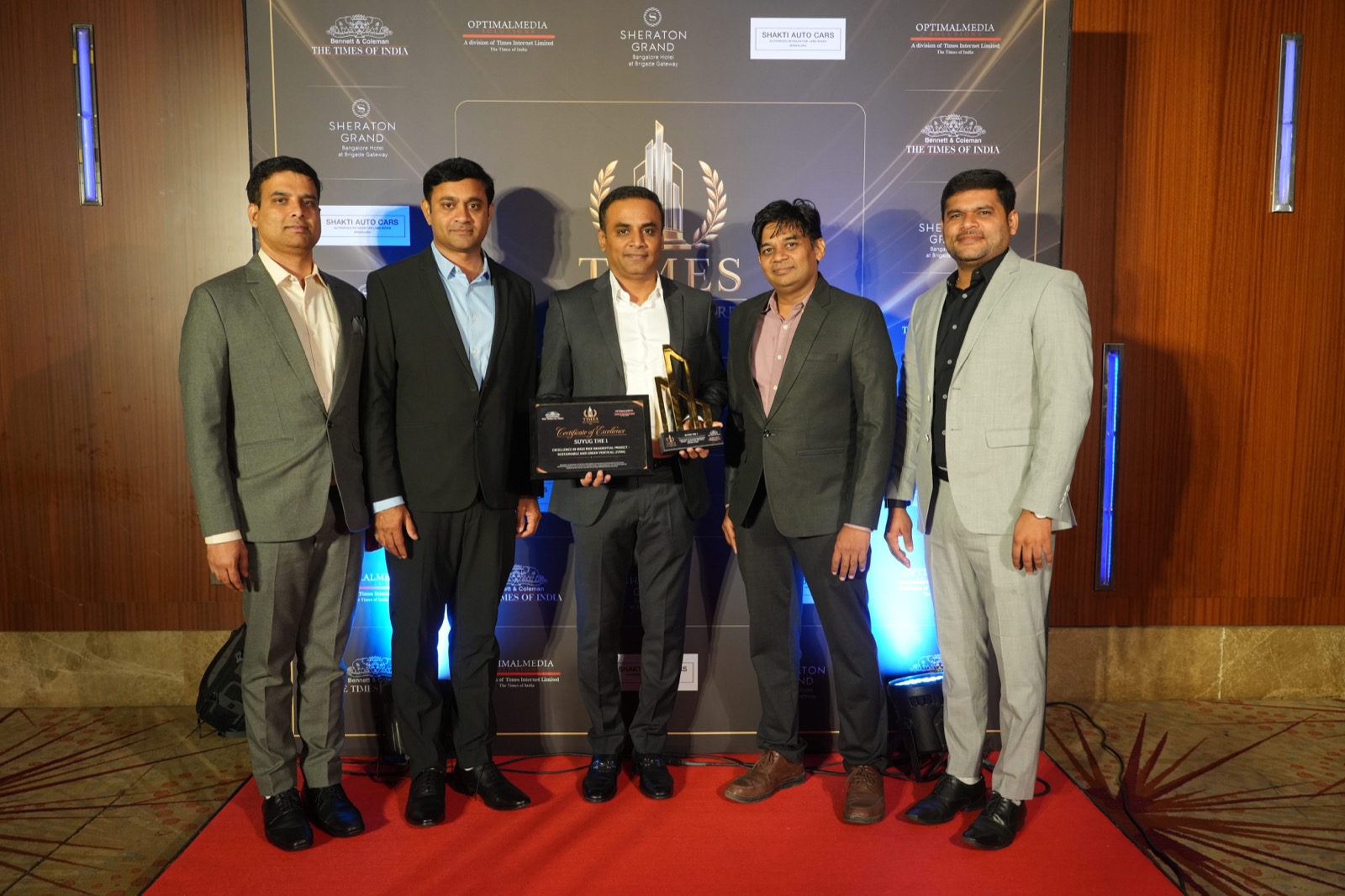 THE1's certificate and trophy with the team at the Times Real Estate Awards