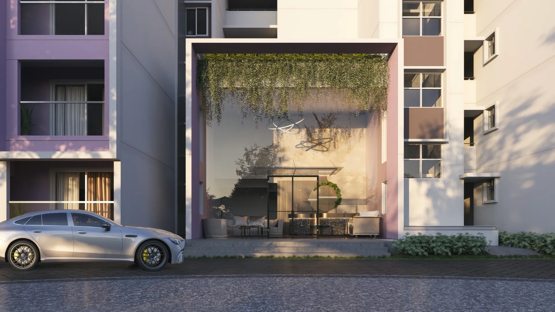 Tower lobby entrance in evening light — a double-height glazed portal framed in terracotta