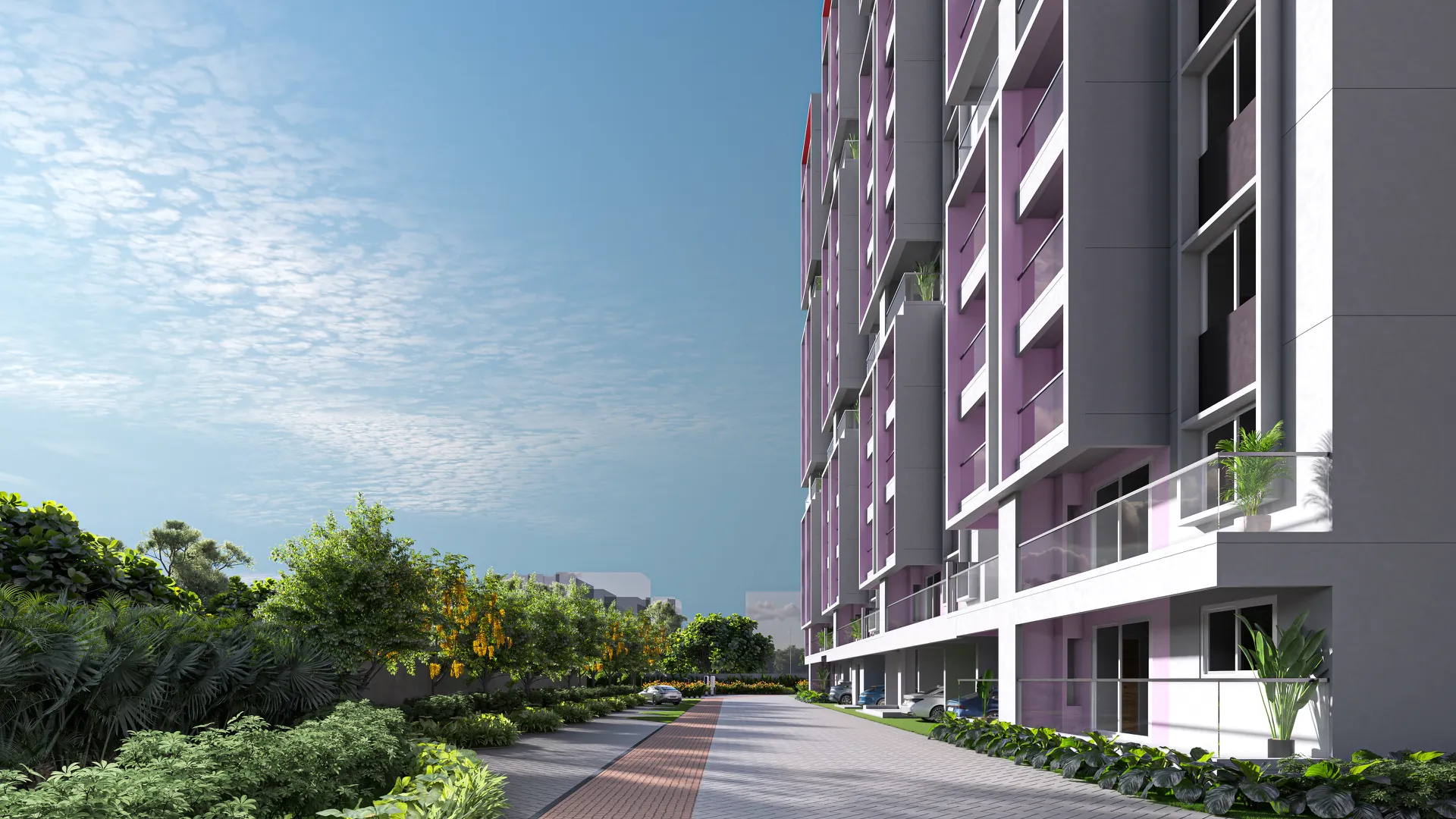 Long view down the driveway beside a residential tower, with the planted edge and flowering trees