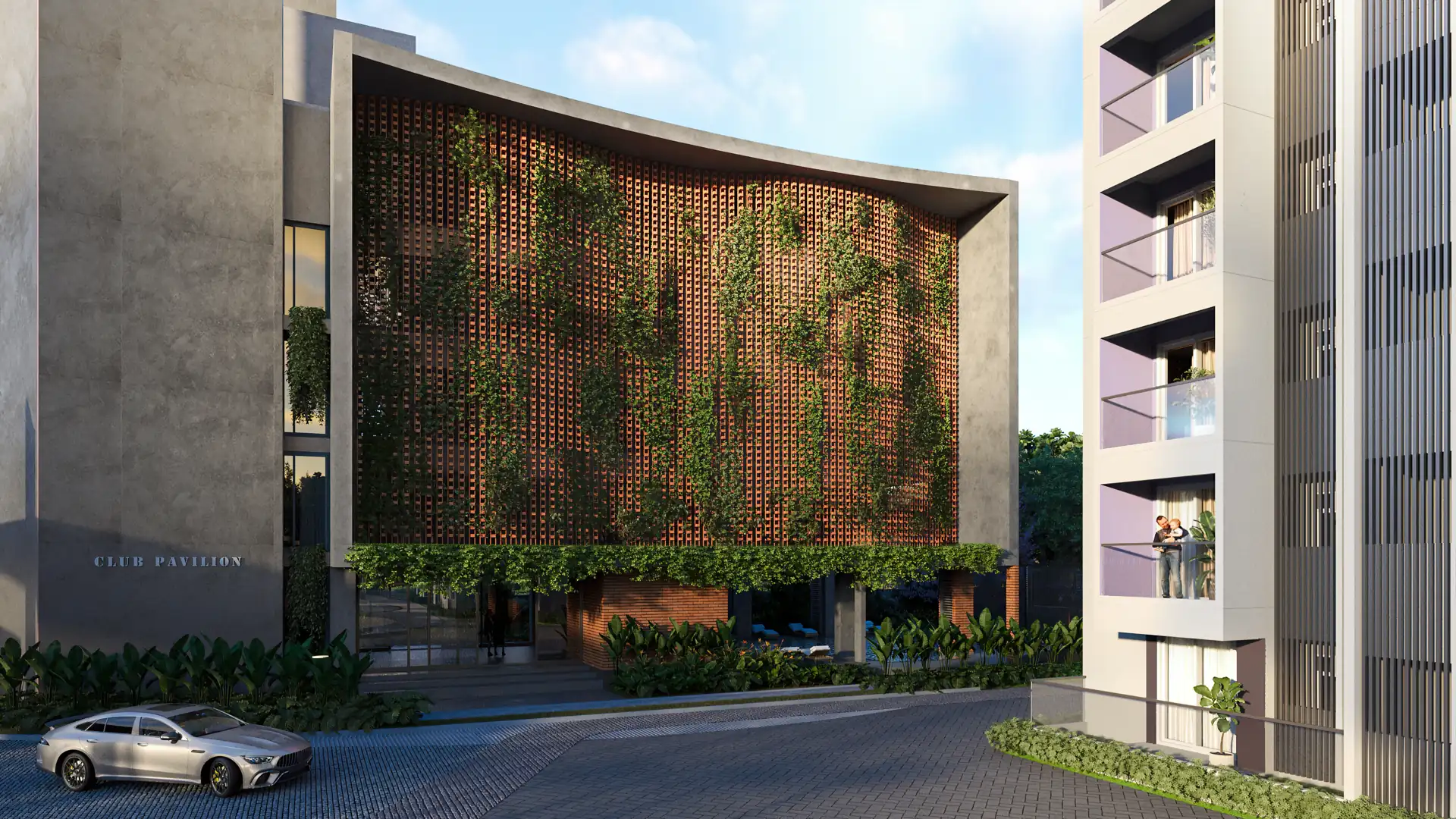 The club pavilion's curved perforated brick screen wall with cascading creepers, seen from the internal driveway beside a residential tower