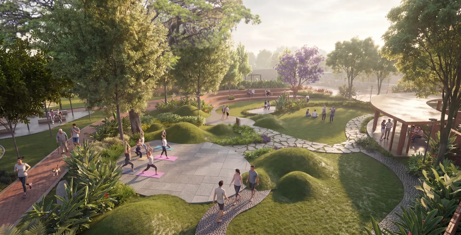 Render of the central park seen wide: stone walking trails run between sculpted grass mounds toward a shaded pavilion.
