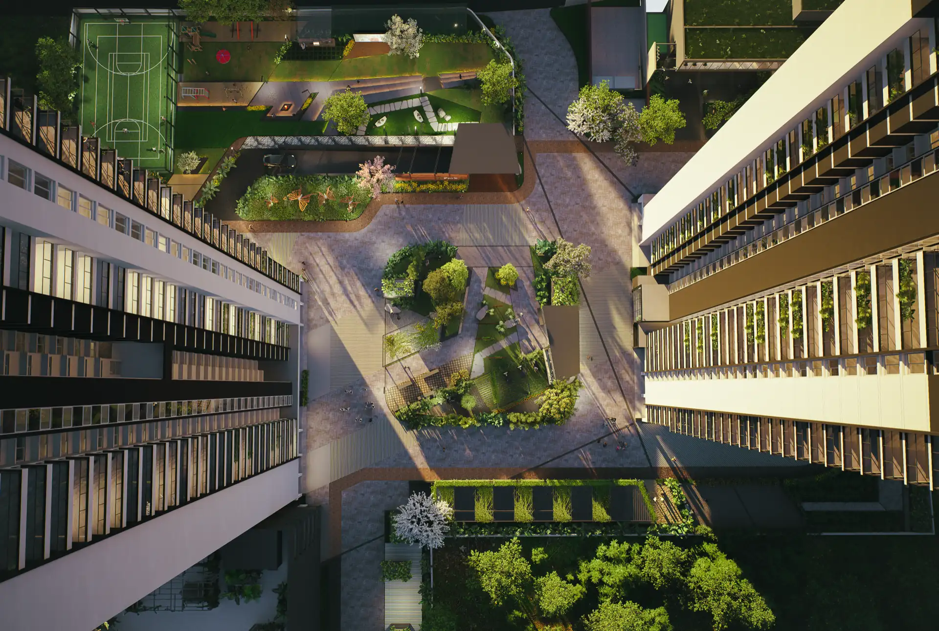 Top-down aerial of the landscaped central courtyard between the residential blocks, with basketball court, children's play area and seating lawns