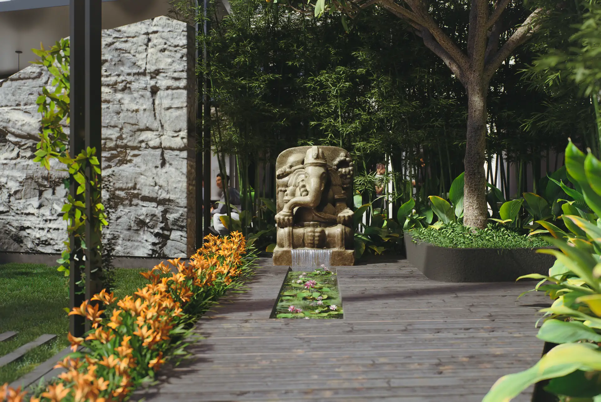 Stone Ganesha water sculpture at the end of a timber deck walkway, framed by bamboo, a lily pond channel and flowering borders