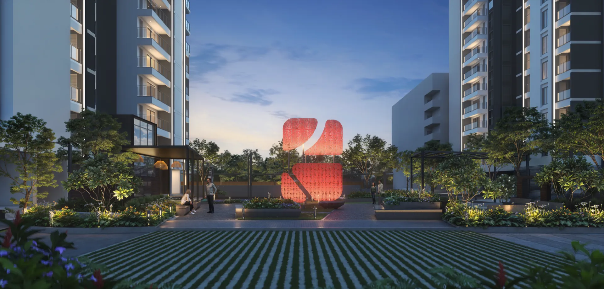 Evening view of the central courtyard between the towers, with the illuminated perforated SUYUG petal sculpture as the focal point