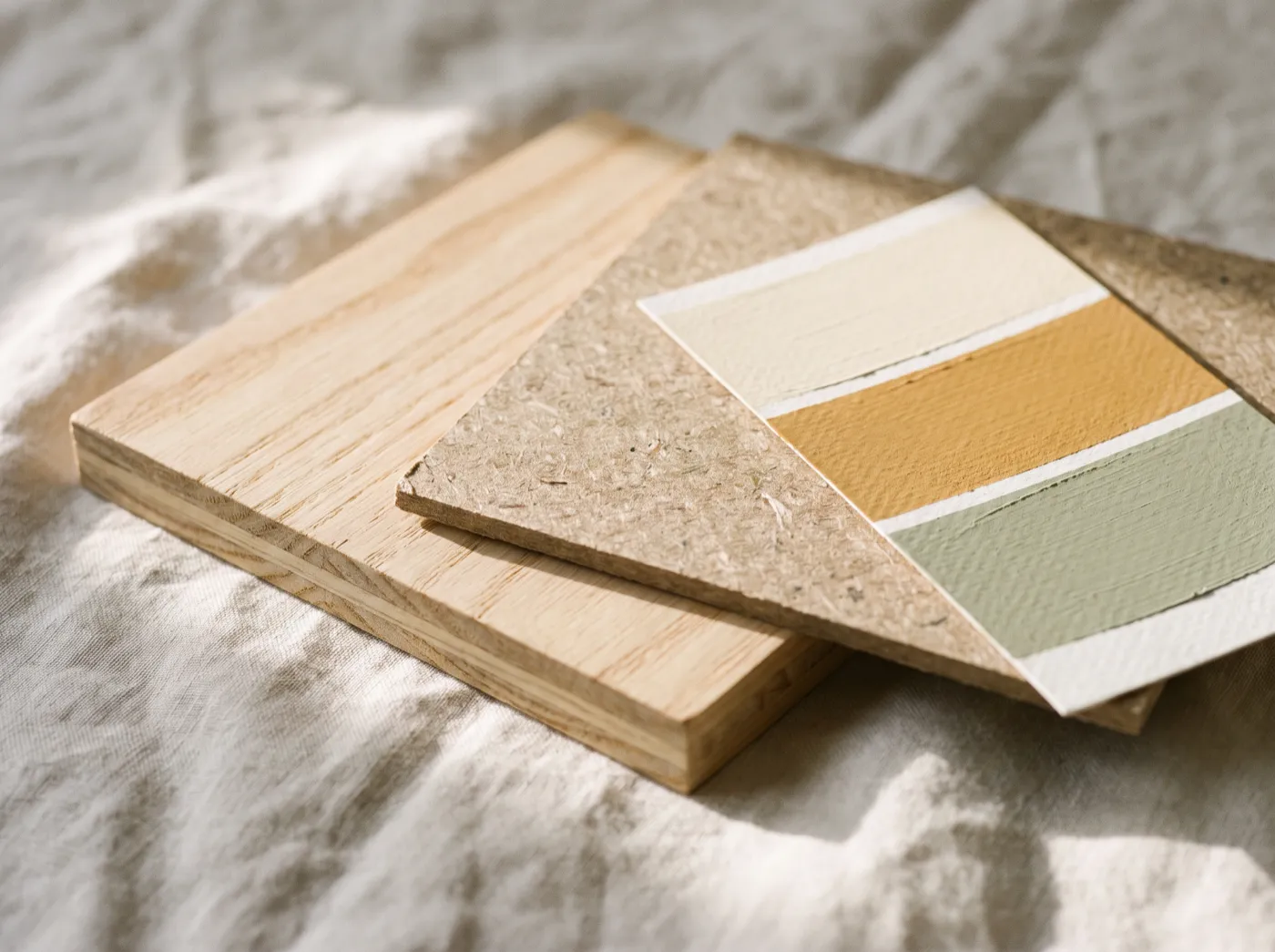 Illustration: samples of engineered timber, particle board and low-VOC paint laid on linen